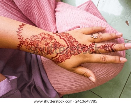 background of hand painted henna with maroon henna and unique design