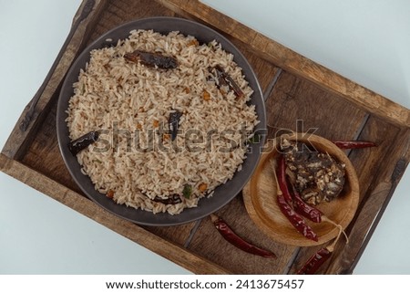 Tamarind Rice  Puliyodharai  Puliyogare - Tangy and spicy South Indian rice dish as break fast , Lunch or dinner. Tamarind as main ingredient and other spices. Famous Tamilnadu dish. Royalty-Free Stock Photo #2413675457