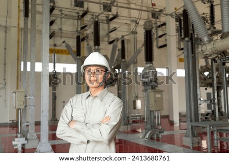 Engineers technicians man wearing professional helmets working in powerhouse or power plant. Royalty-Free Stock Photo #2413680761