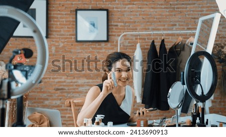 Woman influencer shoot live streaming vlog video review skincare for social media or blog. Happy young girl with vivancy cosmetics studio lighting for marketing recording session broadcasting online.