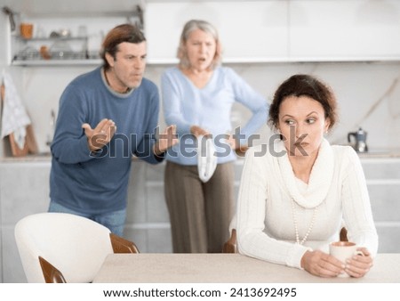 Husband and senior mother-in-low clashed over financial question with woman. Family feuds, generational conflict, misunderstanding due to different views and opinions Royalty-Free Stock Photo #2413692495