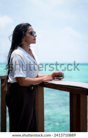 Picture of an Indian model in white dress and shades taken in Maldives