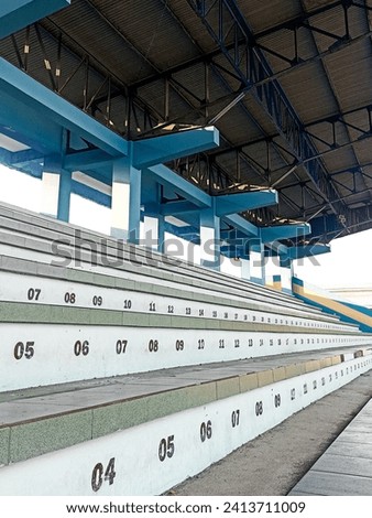 Part of a stadium with empty seats numbered