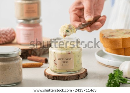 Maple bacon butter, condiment, spread, breakfast, brunch, sweet, savory, butter, maple syrup, bacon bits, smoky flavor, creamy, homemade, garlic-spread Royalty-Free Stock Photo #2413711463