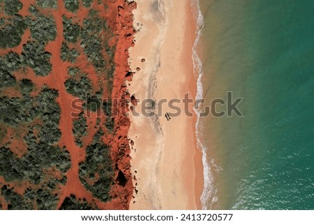 Francois Peron view from the sky. Aerial picture of red sand, beach and the ocean in Shark Bay, Western Australia. Top down of two people on the beach in francois peron national park Australia.