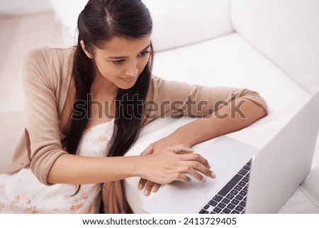Girl on sofa with laptop, search and relax with remote work, website and browse in living room. Woman on couch with computer for freelance job, internet research and reading email online in home.