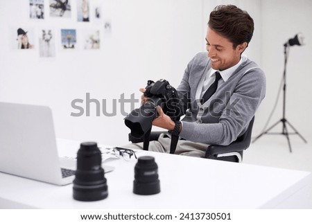 Man, camera and photography in office with happy smile, checking image batch and creative in workplace. Person, thinking and glasses for vision, technology and editor in agency for digital photoshoot