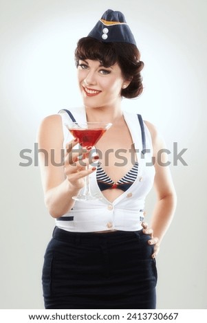 Portrait, stewardess and happy woman with alcohol to drink in studio isolated on white background. Face, martini cocktail glass and air hostess with service, travel and vintage pin up girl on journey
