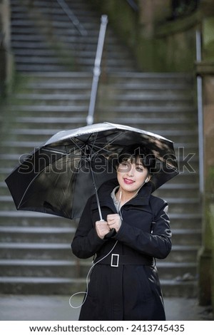 Portrait of a Chinese woman holding umbrella. Lifestyle image.