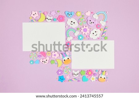 Two blank white cards on pastel purple background with frame of cute kawaii air plasticine handmade cartoon animals, rainbows. Empty photo frames, baby's photo book, scrapbooking design template