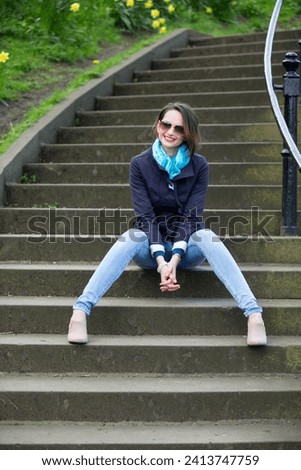 Portrait of an elegant caucasian Woman sitting outdoors. Lifestyle image.