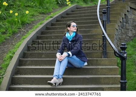 Portrait of an elegant caucasian Woman sitting outdoors. Lifestyle image.