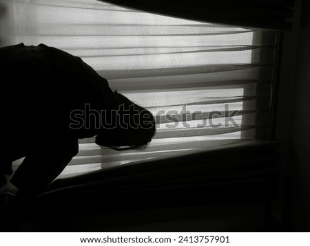 a woman sitting behind a brightly lit window makes the photo underexposed