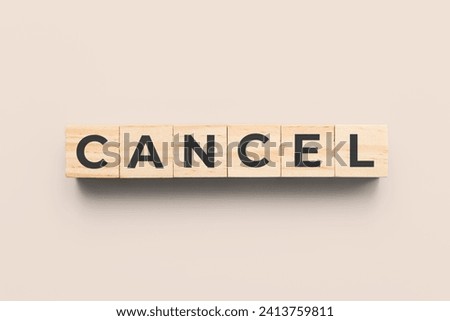 cancel wooden cubes on beige background Royalty-Free Stock Photo #2413759811
