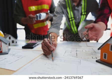 Civil engineering team Creative architects meeting to build a village project. House plans. Blueprints for project design and planning. Foreman. Industrial project manager. teamwork Professional team