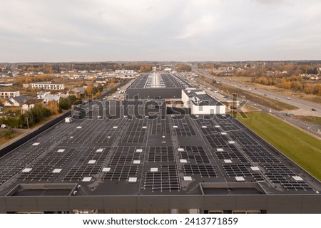 Drone photography of logistical warehouse with solar panels on the roof during autumn sunny morning