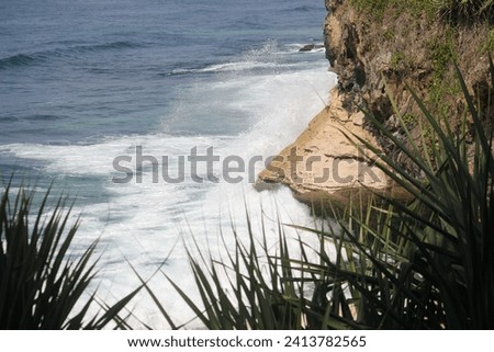 Sea waves are an up and down movement of sea water that occurs due to several factors. Sea waves can be caused by wind, the gravity of the sun and moon, volcanic eruptions or earthquakes at sea Royalty-Free Stock Photo #2413782565