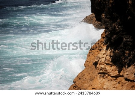 Sea waves are an up and down movement of sea water that occurs due to several factors. Sea waves can be caused by wind, the gravity of the sun and moon, volcanic eruptions or earthquakes at sea Royalty-Free Stock Photo #2413784689