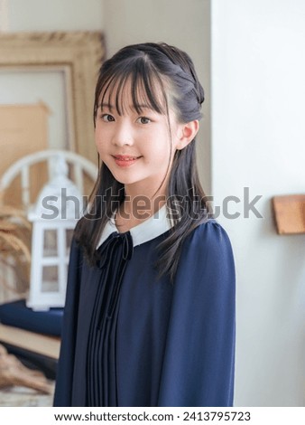 Portrait of Asian little girl wearing school uniform. Photo studio. Memorial photo.