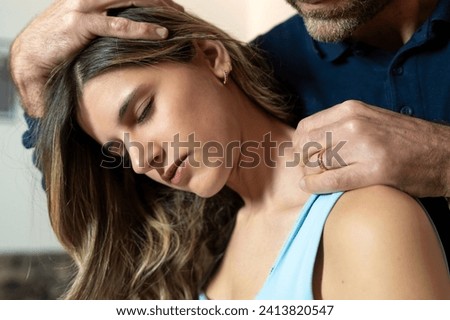 Close-up of a therapist performing a gentle neck massage, focusing on stress relief and relaxation. Royalty-Free Stock Photo #2413820547