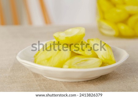 Preserved mango, Thai snack, tropical, sweet, fruity, golden yellow, sugar, drying process, culinary, traditional, homemade, delicacy, culinary delight, gastronomy, food photography, food styling Royalty-Free Stock Photo #2413826379