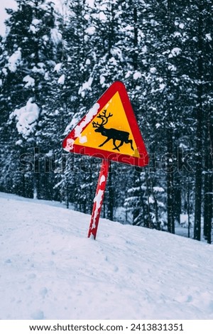 Warning sign for reindeer on Swedish road Royalty-Free Stock Photo #2413831351