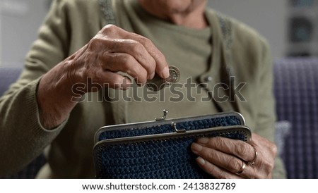 old woman holding paper currency Royalty-Free Stock Photo #2413832789