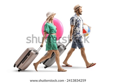 Full length shot of a young couple tourists with suitcases going on a summer vacation isolated on white background Royalty-Free Stock Photo #2413834259