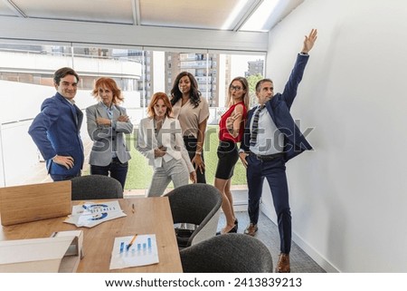 group of multigenerational and multiracial business people, in office, posing jokingly