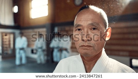 Sensei, aikido and training dojo for martial arts practice or Japanese traditional sport, fighting or health. Male person, gee uniform and face for fitness challenge or power, champion or confidence Royalty-Free Stock Photo #2413847261