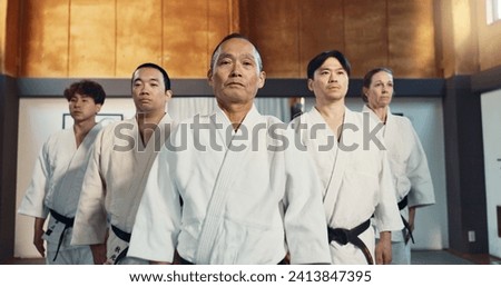 Japanese man, face and sensei in aikido for respect, honor and dignity with group in martial arts class. Portrait of male person or people in commitment for self defense, training or practice at gym Royalty-Free Stock Photo #2413847395
