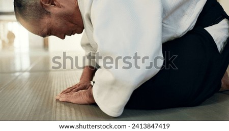 Asian man, student or bow in dojo for respect, greeting or honor to master at indoor gym. Closeup of male person or karate trainer bowing for etiquette, attitude or commitment in martial arts class Royalty-Free Stock Photo #2413847419
