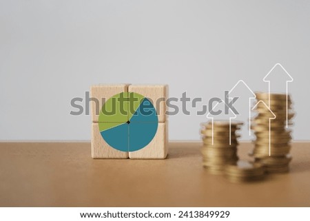 Increase market share, growth of business profit. Market penetration and expansion strategies. Wooden cubes with  pie chart or market share percentage , blurred stack of coins Royalty-Free Stock Photo #2413849929