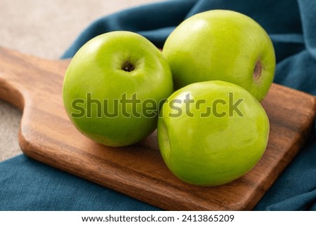 Fresh juicy delicious Taiwanese Milk Indian Jujube fruit in a basket on gray table background. Royalty-Free Stock Photo #2413865209