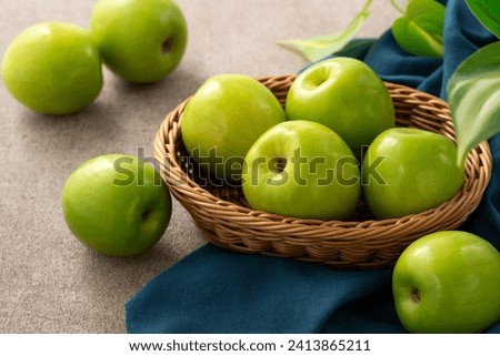 Fresh juicy delicious Taiwanese Milk Indian Jujube fruit in a basket on gray table background. Royalty-Free Stock Photo #2413865211