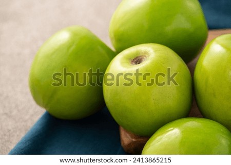 Fresh juicy delicious Taiwanese Milk Indian Jujube fruit in a basket on gray table background. Royalty-Free Stock Photo #2413865215