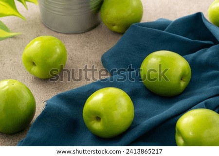 Fresh juicy delicious Taiwanese Milk Indian Jujube fruit in a basket on gray table background. Royalty-Free Stock Photo #2413865217