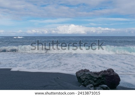 Low-angle view of waves at Pohoiki black sand beach, Isaac Hale Park on the Big Island of Hawaii
