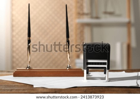 Notary contract. Stamp, documents and pen holder on wooden table