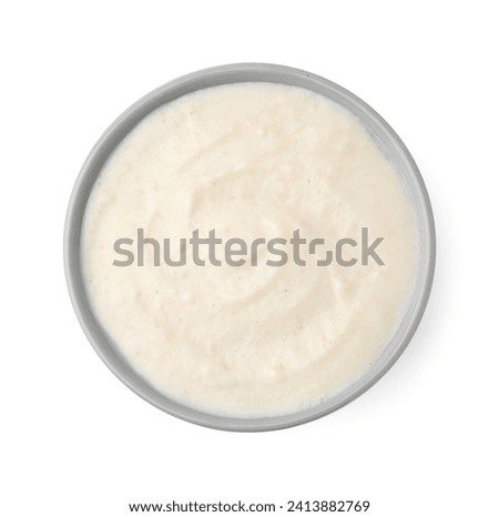 Delicious semolina pudding in bowl isolated on white, top view Royalty-Free Stock Photo #2413882769