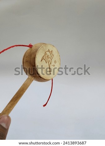 Closeup of Kids Muscial Toys Mucca Sacra Wooden Rattle Toy Damru isolated on white background