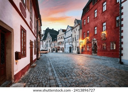 Cesky Krumlov - street in old city at dramatic sunrise, nobody - Czech Republic Royalty-Free Stock Photo #2413896727
