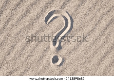 Question mark on sand beach. Concept of questioning, wonder, ask questions