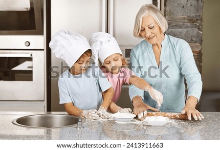 Grandmother of family baking christmas cookies with grandchildren together in her kitchen