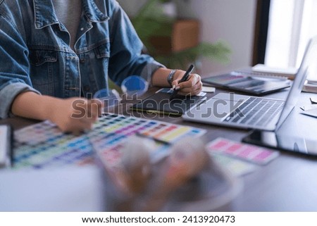 Graphic designer women working on digital tablet and laptop to designing brand logo graphic design.