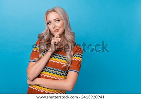 Photo of doubtful suspicious lady wear print shirt arm chin looking empty space isolated blue color background Royalty-Free Stock Photo #2413920941