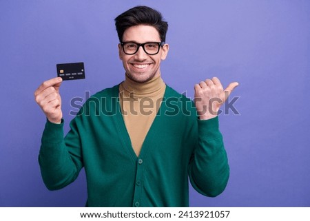 Photo of cheerful attractive gentleman wear trendy clothes presenting empty space transfer transaction isolated on purple color background