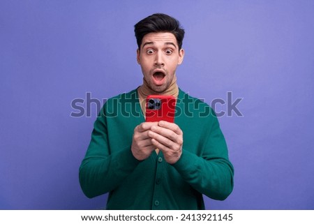 Photo of attractive astonished man wear stylish green clothes read unexpected unbelievable news isolated on purple color background Royalty-Free Stock Photo #2413921145