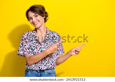 Photo of gorgeous cheerful person beaming smile indicate fingers empty space blank isolated on yellow color background