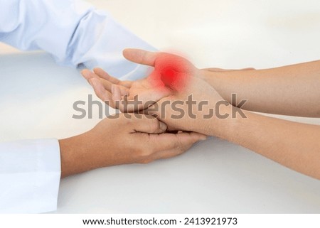 The orthopedic doctor or surgeon in uniform examined the patient with numbness of hand.Wrist pain in carpal tunnel syndrome with red light effect.Light effect on white background.